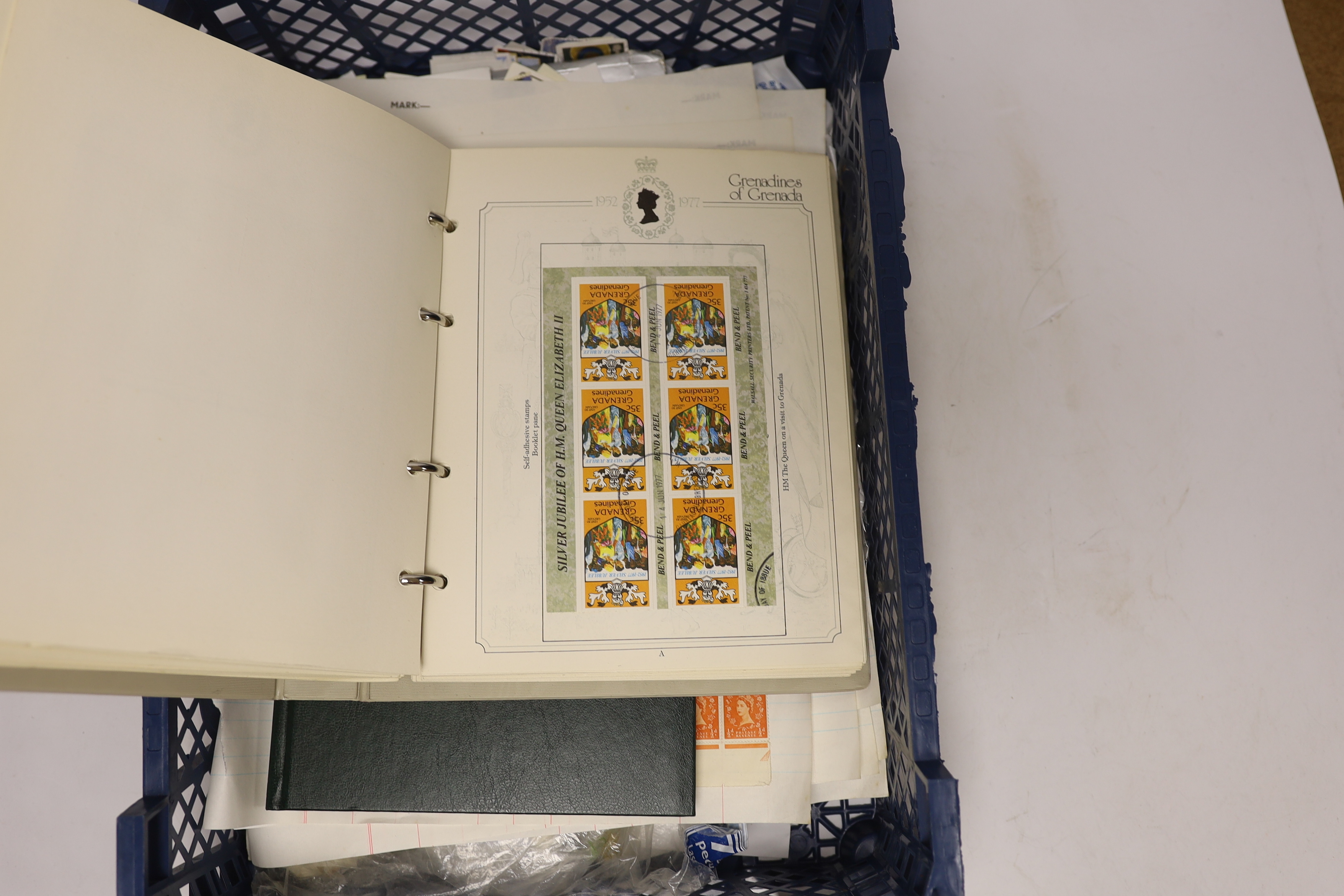 Two stamp albums and various loose pages and bags of loose stamps